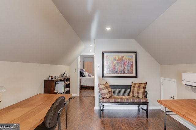 office space with lofted ceiling, an AC wall unit, baseboards, and wood finished floors