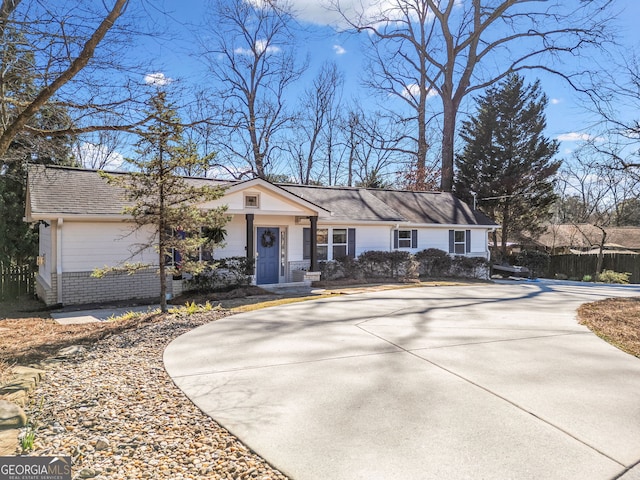 view of front of house with concrete driveway and brick siding