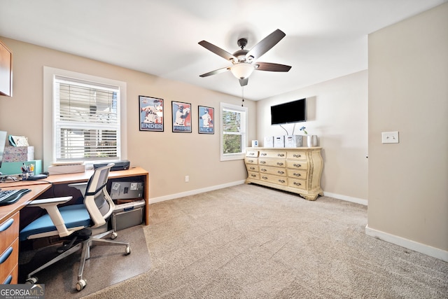 carpeted home office featuring ceiling fan and baseboards