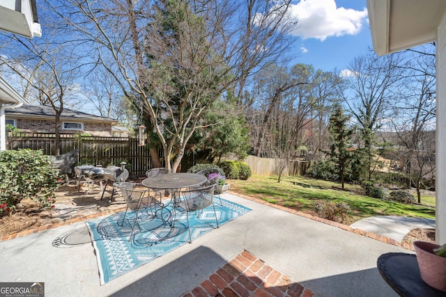 view of patio with outdoor dining space and a fenced backyard