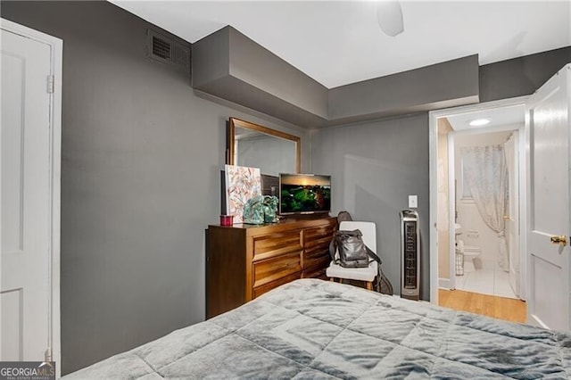 bedroom featuring wood finished floors and visible vents