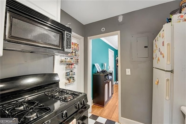 kitchen with light wood-type flooring, electric panel, black appliances, and white cabinetry