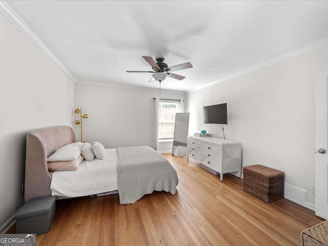 bedroom with ceiling fan, ornamental molding, and wood finished floors