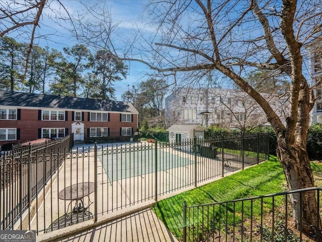 view of pool featuring fence, an outbuilding, a fenced in pool, and a patio