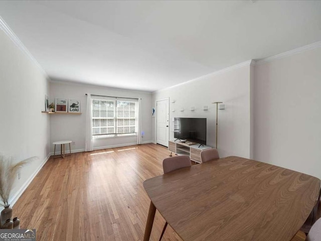 unfurnished living room featuring ornamental molding, light wood-style flooring, and baseboards