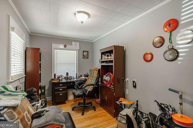 office space featuring crown molding and light wood-style floors