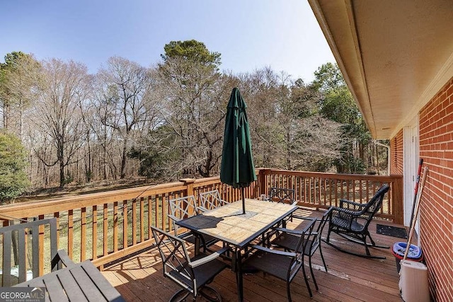 wooden terrace with outdoor dining area