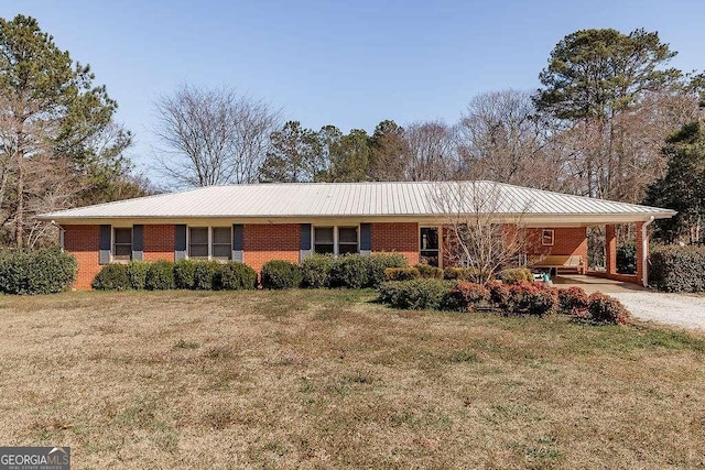 single story home featuring brick siding, metal roof, and a front yard