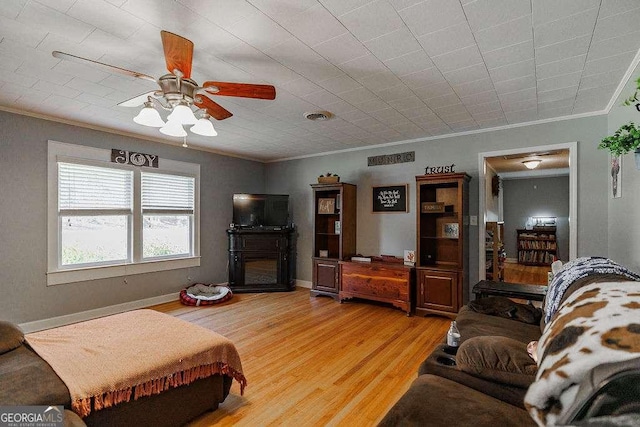 interior space featuring light wood-style flooring, visible vents, baseboards, and ornamental molding