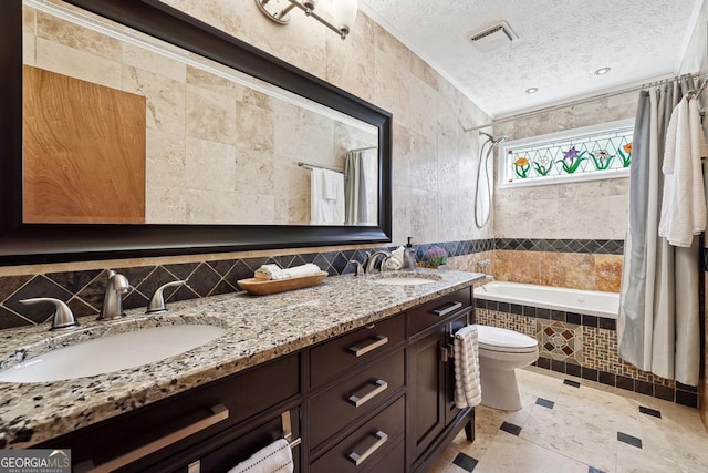 full bathroom with tile walls, a sink, tiled shower / bath, and a textured ceiling