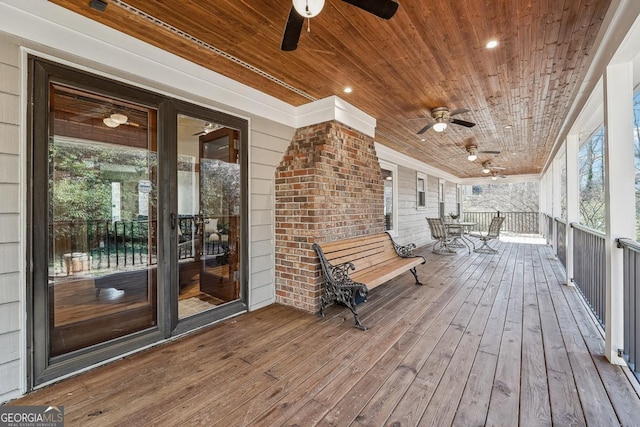 wooden terrace featuring a ceiling fan