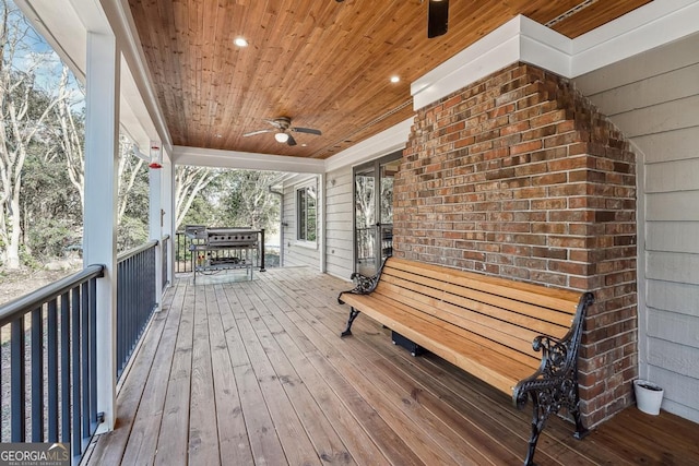 wooden terrace featuring ceiling fan