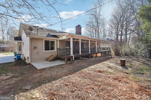 back of property with a patio area and a chimney