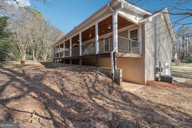 view of home's exterior featuring ceiling fan and central AC unit