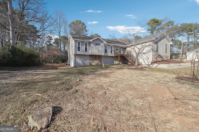 view of front of home with a wooden deck, stairway, and a front yard