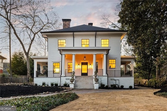 view of front of property with a porch and a chimney