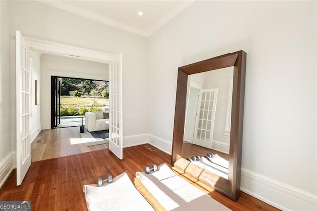 interior space featuring recessed lighting, french doors, baseboards, and wood finished floors