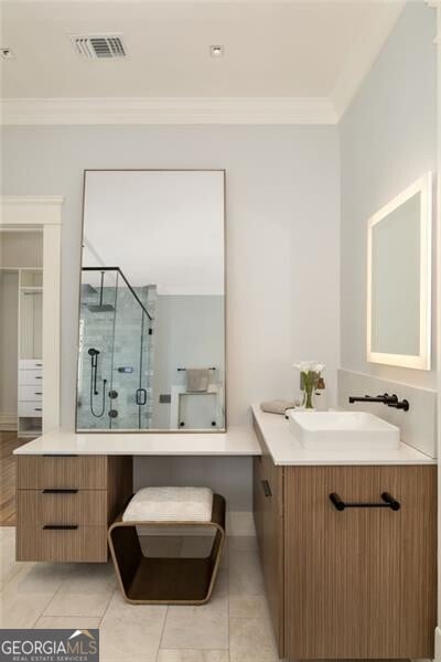 bathroom with two vanities, a sink, visible vents, a stall shower, and crown molding