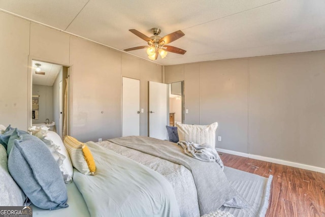 bedroom with dark wood-type flooring, ceiling fan, and baseboards