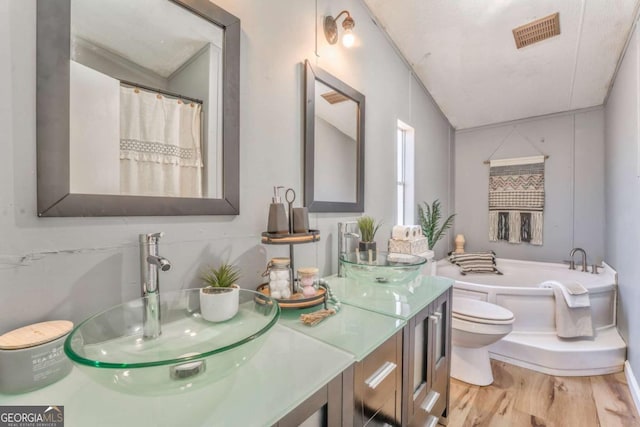 full bathroom with a garden tub, double vanity, a sink, and visible vents