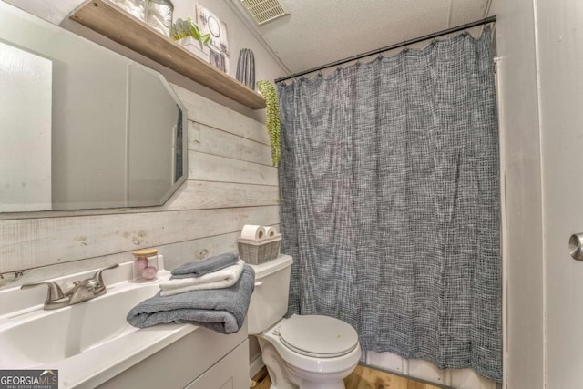 full bath with curtained shower, visible vents, toilet, a textured ceiling, and vanity