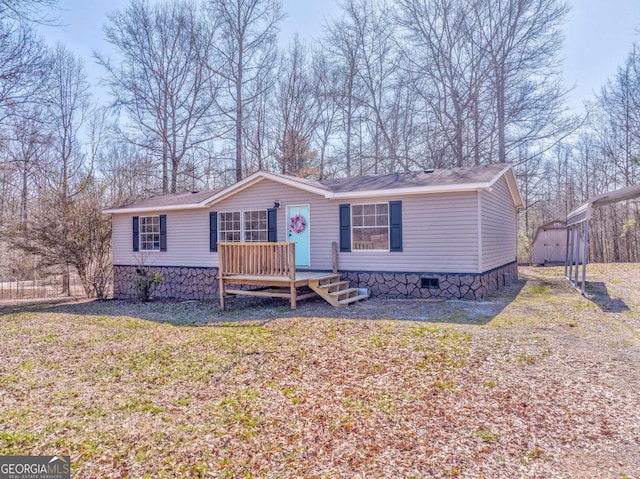 manufactured / mobile home with a front lawn, crawl space, an outdoor structure, and a storage shed