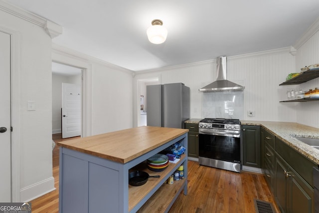 kitchen featuring open shelves, stainless steel appliances, visible vents, butcher block countertops, and wall chimney exhaust hood