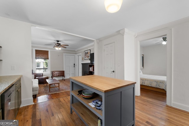 kitchen with crown molding, open shelves, wood counters, dishwasher, and hardwood / wood-style flooring