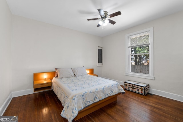 bedroom featuring baseboards, ceiling fan, and hardwood / wood-style floors