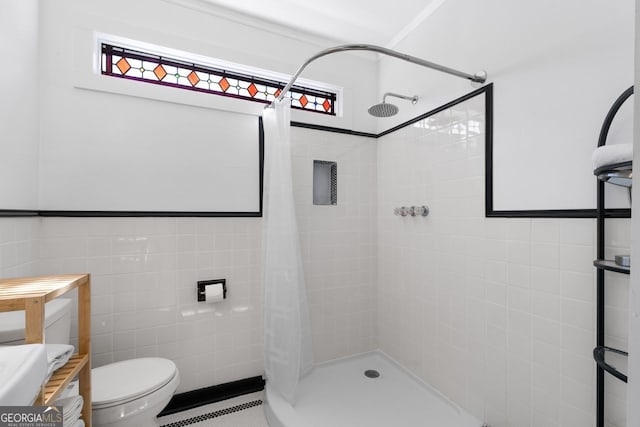 full bathroom featuring a healthy amount of sunlight, toilet, tile walls, and a shower stall