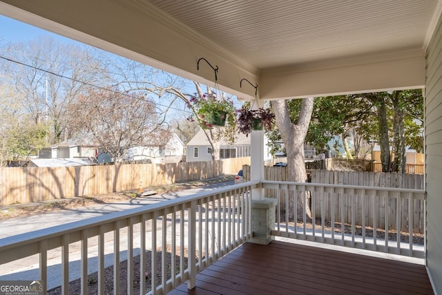 wooden terrace featuring fence and a residential view