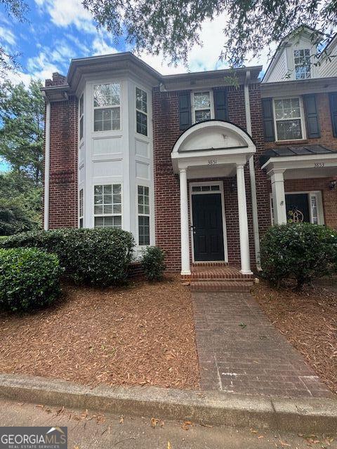 view of front facade featuring brick siding