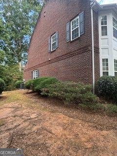 view of property exterior with brick siding