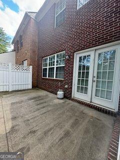 view of home's exterior with brick siding and fence