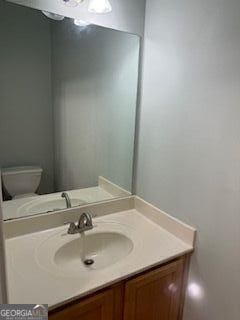 bathroom featuring toilet and vanity