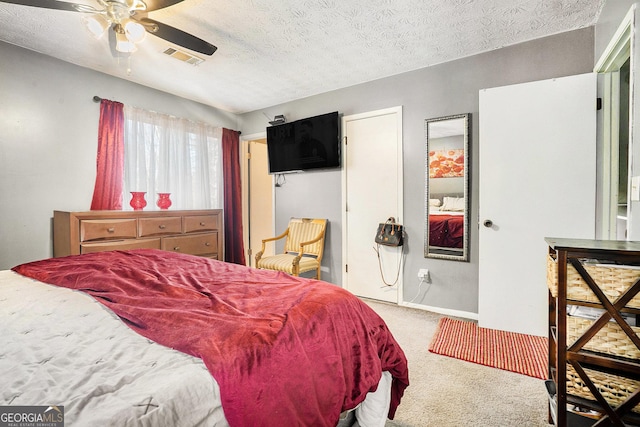 bedroom with baseboards, visible vents, a ceiling fan, a textured ceiling, and carpet flooring