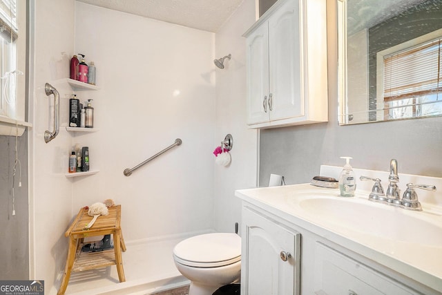 full bath featuring toilet, walk in shower, a textured ceiling, and vanity