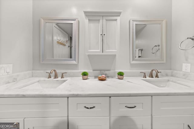 full bathroom featuring double vanity and a sink