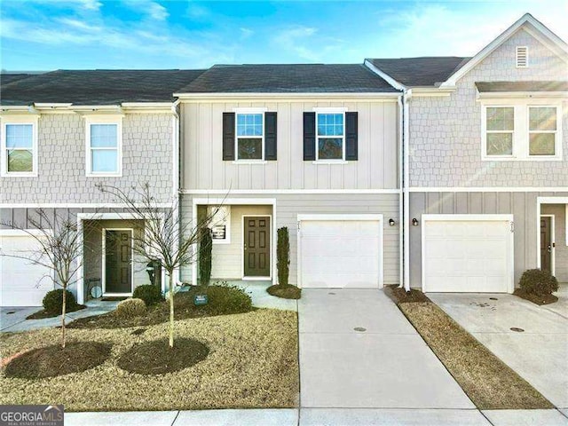 townhome / multi-family property featuring board and batten siding and concrete driveway