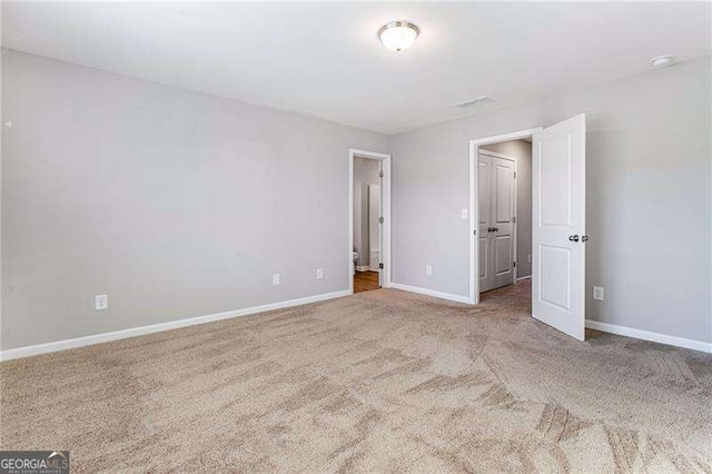 unfurnished bedroom with carpet floors and baseboards