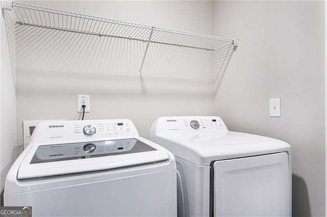 clothes washing area featuring laundry area and washer and dryer