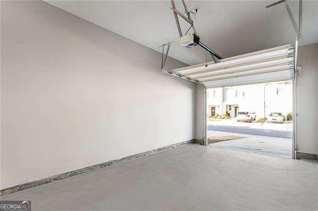 garage with baseboards and a garage door opener