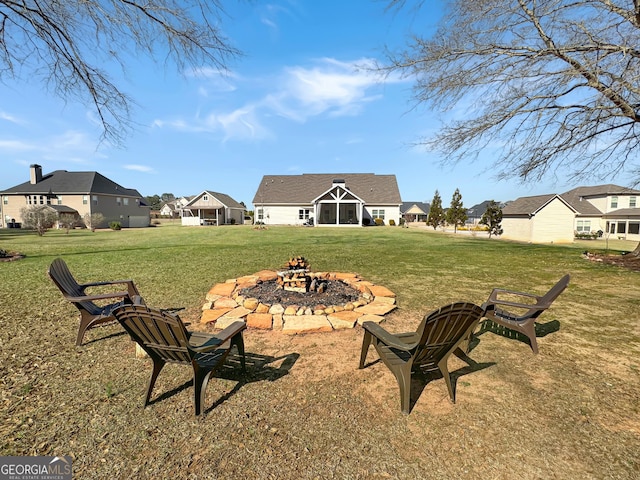 view of yard with a residential view and an outdoor fire pit