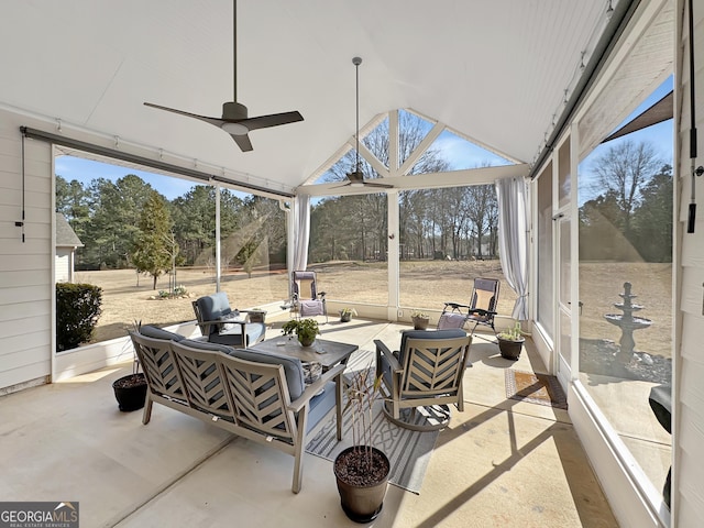 sunroom featuring lofted ceiling and ceiling fan