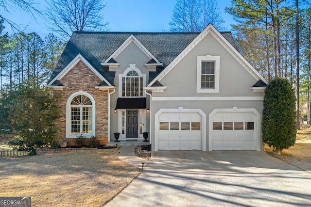 traditional home with driveway, a shingled roof, and stucco siding