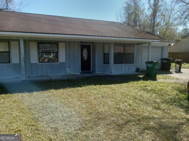 single story home with roof with shingles, board and batten siding, and a front yard