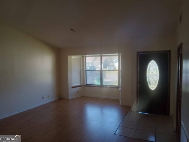 foyer entrance featuring baseboards and wood finished floors