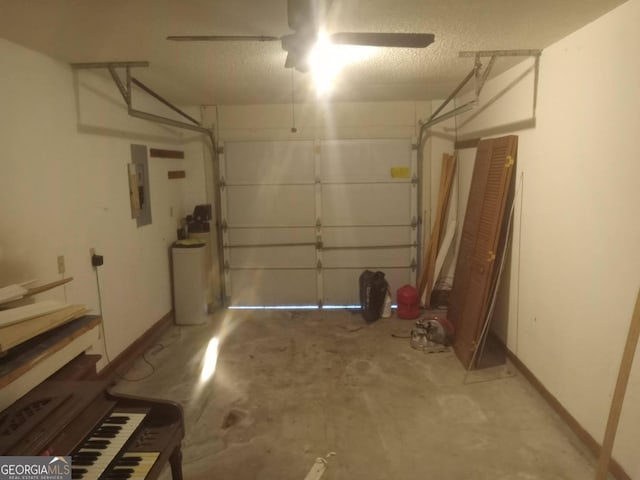 garage featuring electric panel, baseboards, and a ceiling fan