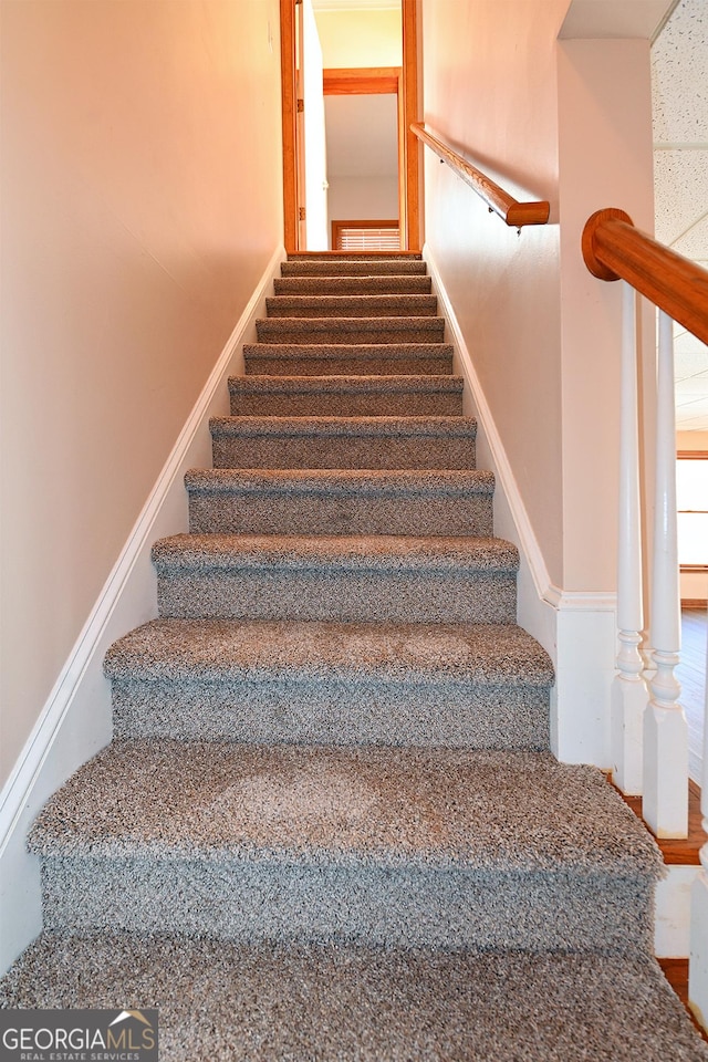 stairway featuring baseboards