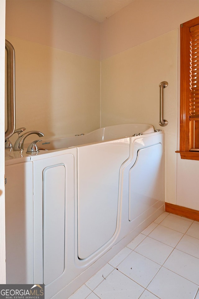 clothes washing area featuring light tile patterned floors and washer / clothes dryer